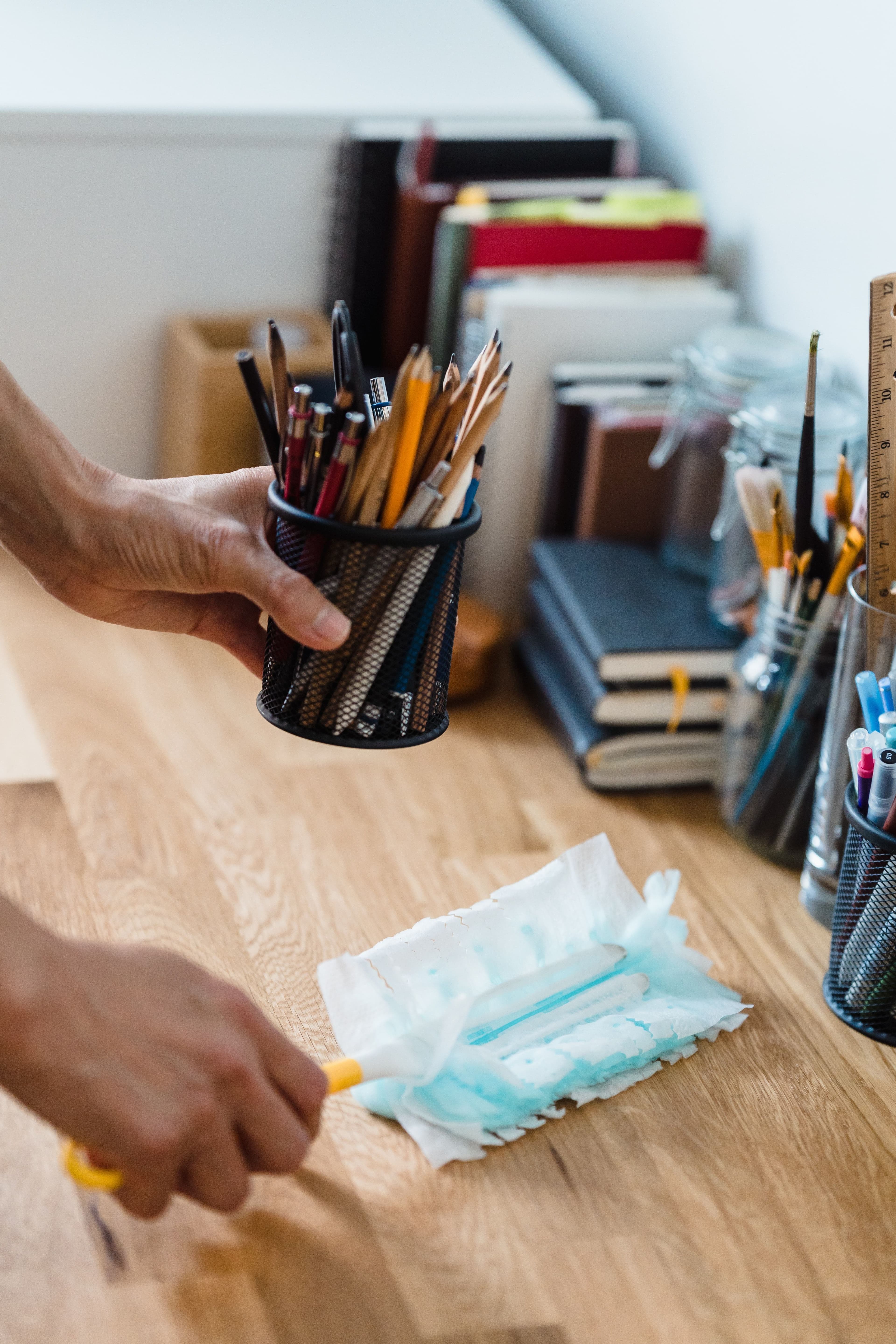 Image of employee dusting an office space.